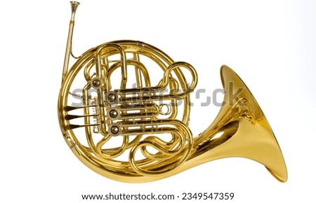 French horn: A coiled brass instrument played with valves and a wide bell, producing warm, rich tones. Royalty-Free Stock Photo #2349547359