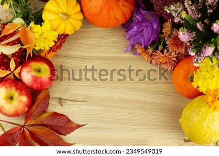 Autumn background, vegetables, fruits and leaves on a wooden board, flat lay. Bright ripe pumpkins and apples with yellow autumn leaves on a postcard. Halloween, thanksgiving, autumn holiday. High