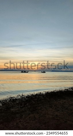 Sunset Picture. This is a beautiful seascape with sailing boats and sunset in the background.
