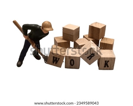 you can see a worker doing his job and next to him there is a wooden block that says "work"