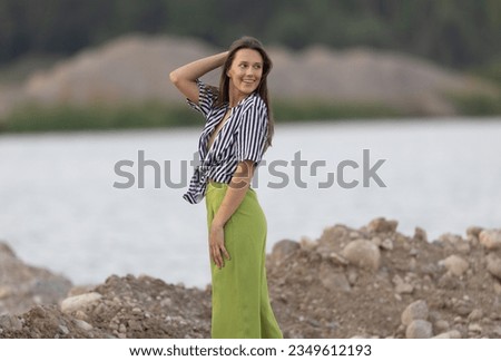 Gorgeous hippie girl model enjoying a summer evening outdoors in a gravel pit Royalty-Free Stock Photo #2349612193