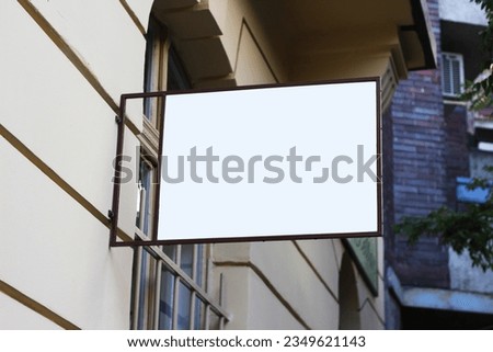 Street storefront shop, cafe, restaurant mounted signboard mock up design template. Blank white store sign design mockup.