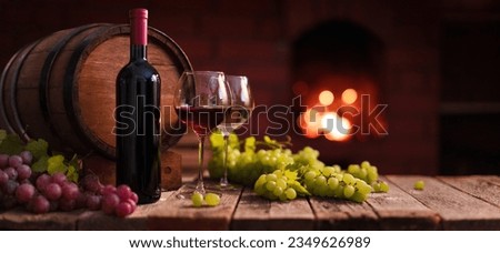 Red and white wine. A glass of red and white wine with grapes on the background of a homemade fireplace