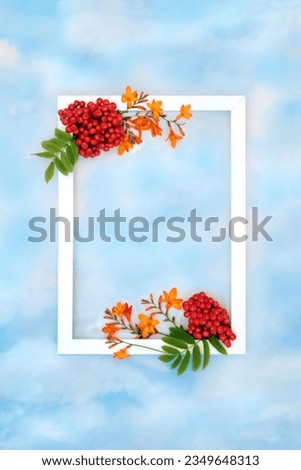 Autumn harvest festival fruit and flower background border with white frame on blue sky and cloud. Festive floral fall Thanksgiving nature concept for label, card, invitation, menu. Royalty-Free Stock Photo #2349648313