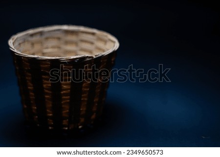 Empty flower basket in an isolated black background space for a text works bamboo basket