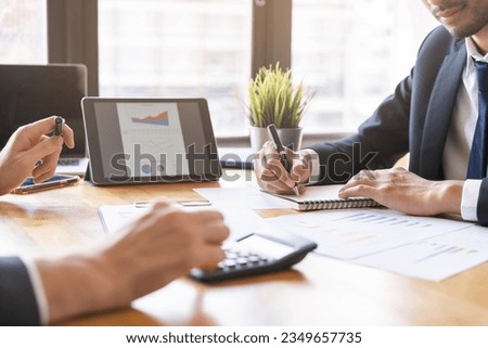 Business professional people group, team of young asian, caucasian working and communicating, analyzing data, discussing, using calculator calculate explain cost about new project with colleagues. Royalty-Free Stock Photo #2349657735