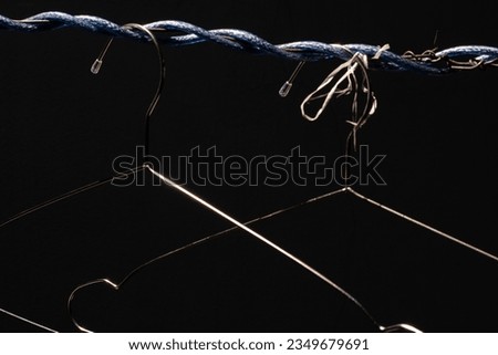 Laos drying clothes with wires tangled around and tied with ropes, creating a strange picture in dark tones.