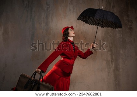 Mary Poppins. A stylish lady in a red old-fashioned suit with a hat and a lace umbrella Royalty-Free Stock Photo #2349682881