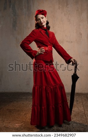 Mary Poppins. A stylish lady in a red old-fashioned suit with a hat and a lace umbrella Royalty-Free Stock Photo #2349682907