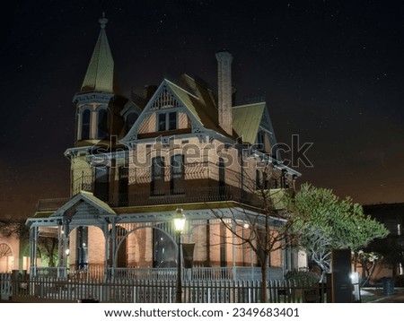 Photo of a beautifully illuminated Victorian house at night Royalty-Free Stock Photo #2349683401