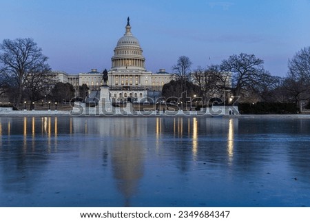 U.S. Capitol Building reflecting in frozen pool in Washington, DC USA Royalty-Free Stock Photo #2349684347