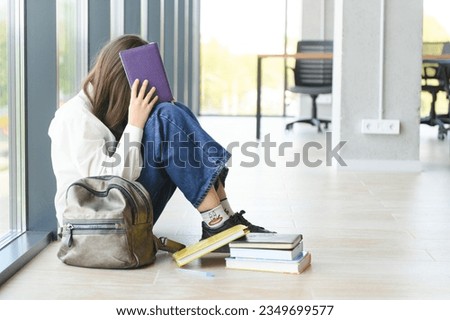 Lonely sad schoolgirl while all her classmates ignored her. Social exclusion problem. Bullying at school concept Royalty-Free Stock Photo #2349699577