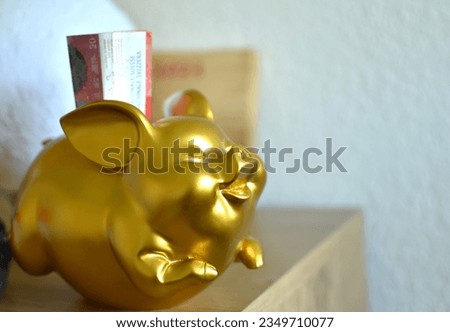 golden pig piggy bank and 20 swiss francs