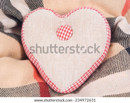 Fabric linen handmade heart on a warm scarf