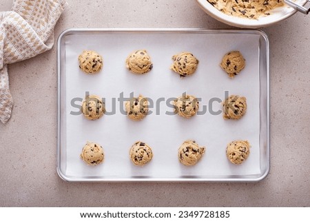 Chocolate chip cookie dough scooped on a cookie sheet ready to be baked Royalty-Free Stock Photo #2349728185