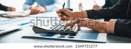 Auditor and accountant team working in office, analyze financial data and accounting record with calculator. Accounting company provide finance and taxation planning for profitable cash flow. Insight Royalty-Free Stock Photo #2349731277