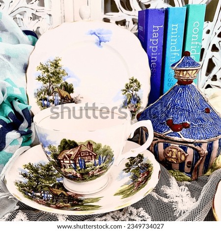 Pretty tea cup scene with plates and flowers