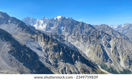 Ala-Archa National Park, Kyrgyzstan. Beautiful mountain summer landscape. Views from the ascent to Komsomolets peak. Amazing mountain valley, view from a height. Snow-capped peaks in the distance.
