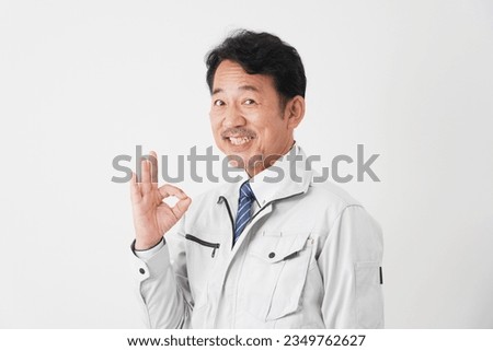Asian middle aged worker OK gesture in white background
