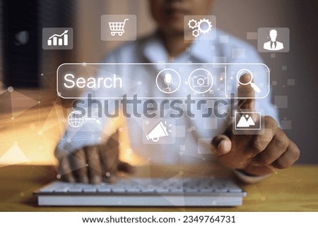 Businessman in white working with pc wireless keyboard reach out to touch on magnify search engine bar including search with picture image and voice. SEO search engine optimization concept.