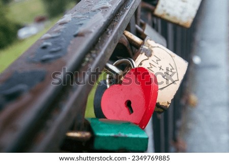 Red heart shaped lock on a bridge, love symbol