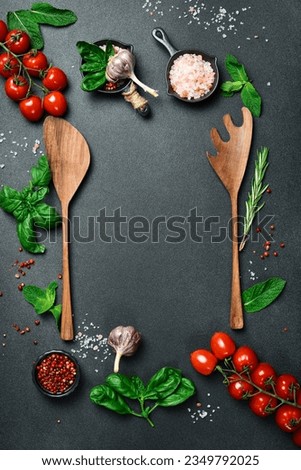 Kitchen banner. A set of vegetables and kitchen utensils on a black table. Free space for text. Top view. Royalty-Free Stock Photo #2349792025