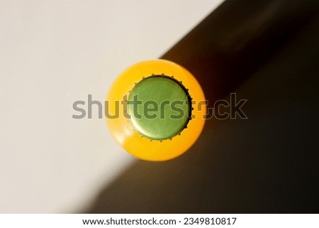 Lemonade Bottle and a Shadow on table view from above. Closeup Flat lay Photography for Banner, Promotion, Ptinting, Poster. Fresh and juicy non-alcoholic Summer drink.