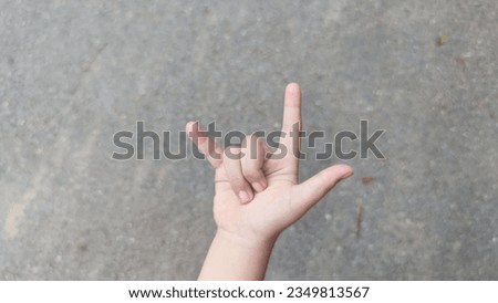 The symbol "l love you" from the hand of a small child suitable for assembly Royalty-Free Stock Photo #2349813567