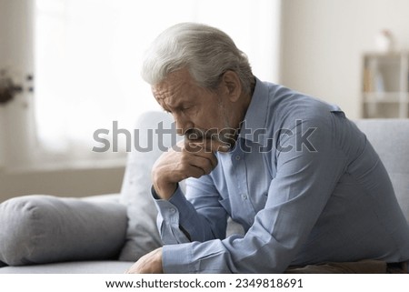 Sad lonely grey haired old man thinking on geriatric health problems, bored retirement at home, feeling sick, tired, suffering from depression, memory loss, mental disorder Royalty-Free Stock Photo #2349818691