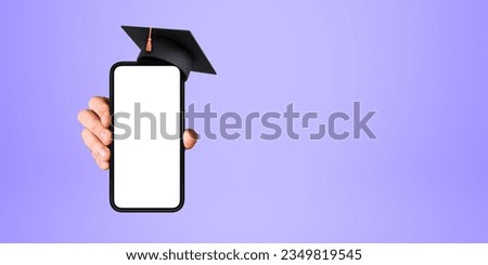 Hand showing a phone mockup blank display with graduation hat, empty purple background. Concept of online education, website, e-learning and career choice