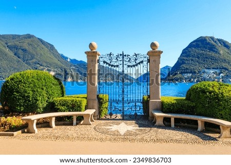 Old wrought iron gate overlooking Lake Lugano in Ciani Park, Lugano, Switzerland Royalty-Free Stock Photo #2349836703