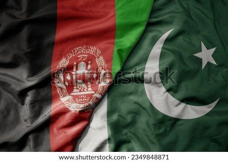 big waving realistic national colorful flag of afghanistan and national flag of pakistan . macro Royalty-Free Stock Photo #2349848871