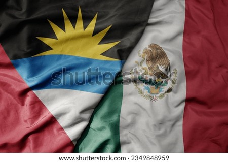 big waving realistic national colorful flag of antigua and barbuda and national flag of mexico . macro