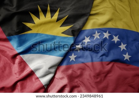 big waving realistic national colorful flag of antigua and barbuda and national flag of venezuela . macro