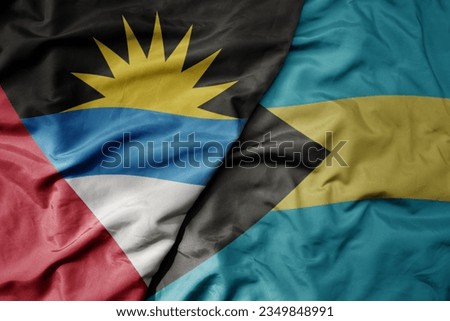 big waving realistic national colorful flag of antigua and barbuda and national flag of bahamas . macro