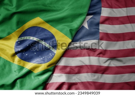 big waving realistic national colorful flag of brazil and national flag of liberia . macro