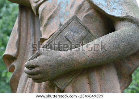 Angel sculpture with Bible in hand