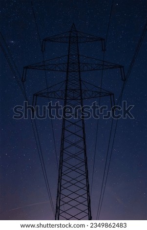 Powerline in front of blueish purple nightsky
