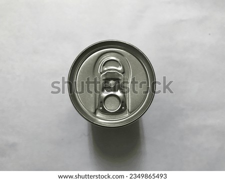 a silver-colored beverage can made of aluminum, the can has not been opened and is still sealed or closed.