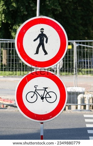 Two traffic signs forbidding entrance for pedestrians and cyclists as the crossing is reconstructed.