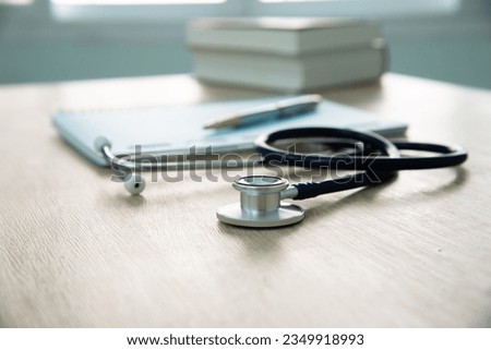 In a hospital setting, the presence of a doctor's physician book and stethoscope carries with it an air of professionalism and dedication to patient care. Royalty-Free Stock Photo #2349918993
