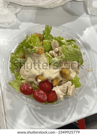 Take a picture of a box of salad bought at the mall