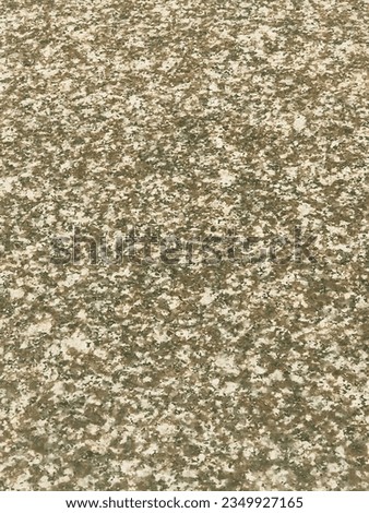 The granite has a smooth texture with intricate patterns and specks of various shades of brown. The surface appears well-polished, reflecting light and enhancing the richness of the brown tones.