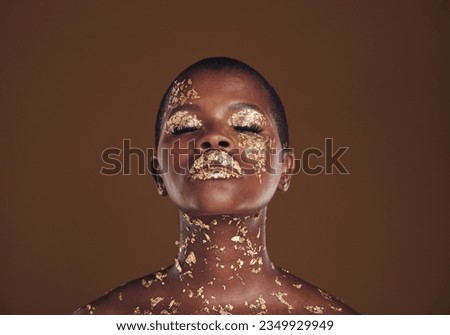 Beauty, glitter and black woman with gold makeup on brown background with art, paint and cosmetics. Shine, glow and African model in studio for facial fashion, aesthetic freedom and luxury skincare.