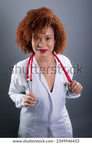 Veterinarian woman, beautiful with red hair, in white uniform and holding a stethoscope. Animal care. Isolated on gray background.