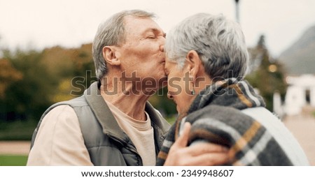 Kiss, forehead and senior couple in a park with love, happy and conversation with romantic bonding. Kissing, old people and elderly man embrace woman with care, romance or soulmate connection outdoor Royalty-Free Stock Photo #2349948607