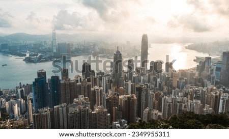 Cityscape landscape view of Hong Kong island in sunny morning, high angle view. Skyscraper buildings in financial district, ship transportation on Victoria harbour. Asia tourism travel concept