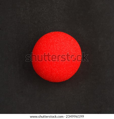 Clown nose on a chalkboard background Royalty-Free Stock Photo #234996199