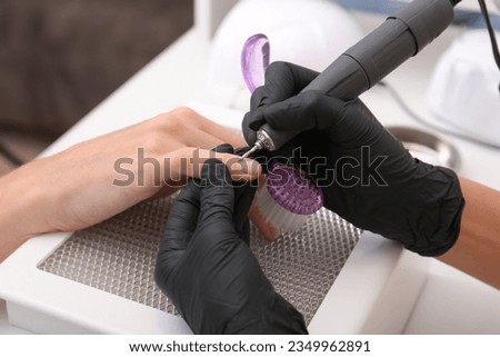 Professional manicurist working with client, closeup view Royalty-Free Stock Photo #2349962891