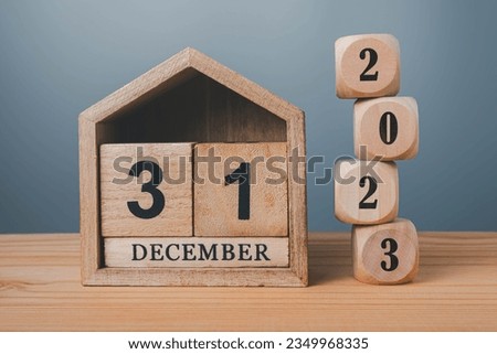 Wooden blocks lined up with 2023 numbers and wooden house on December 31st, last day of the year goal concept. Royalty-Free Stock Photo #2349968335